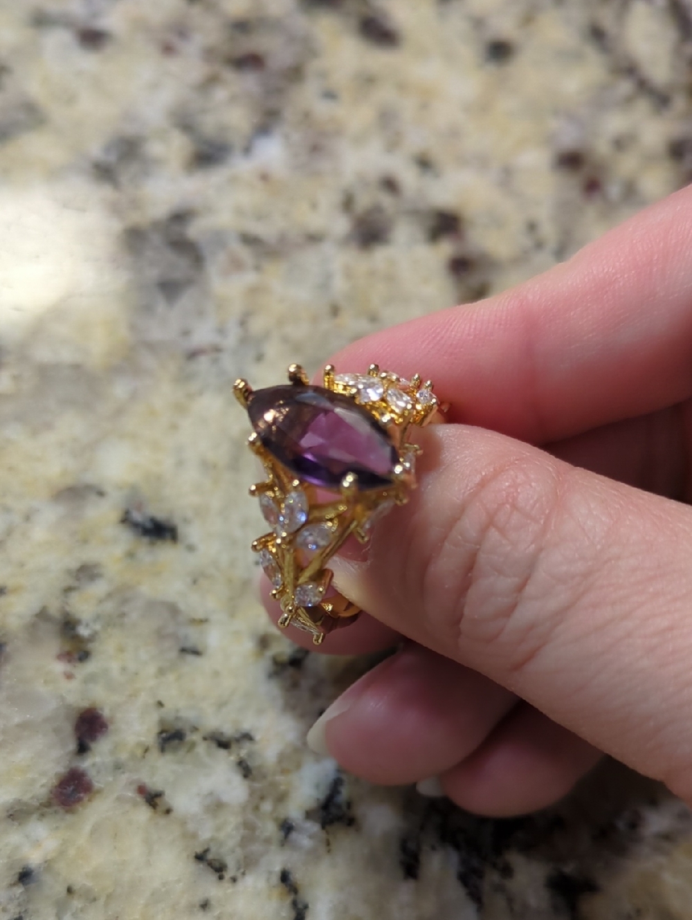 Gold Ring with Teardrop Purple Stone and Clear Accent Stones